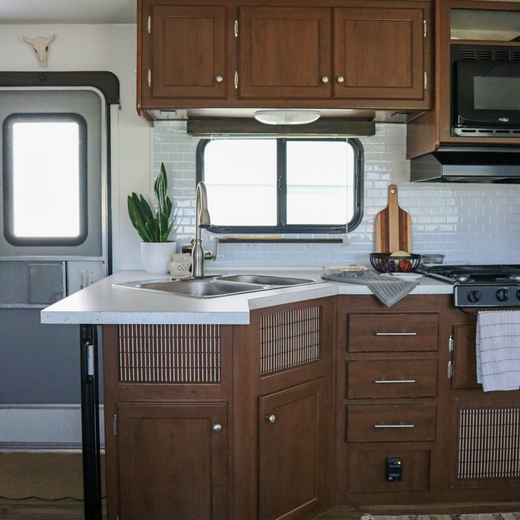 An RV kitchen with LED under-cabinet lighting.