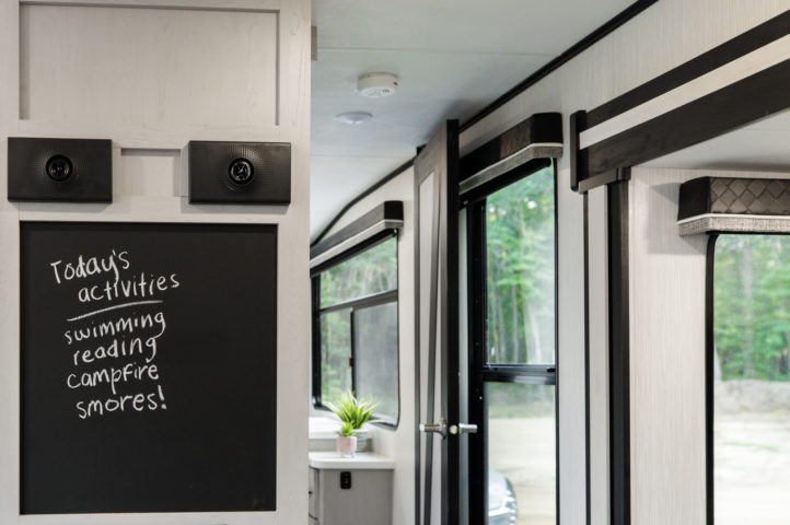 A chalkboard hanging inside an RV with a list of fun activities to do.