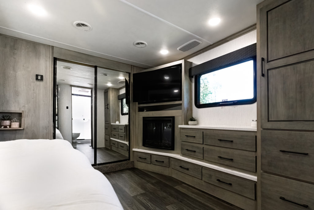 The Big Country bedroom with a mounted flat-screen TV on the wall. 